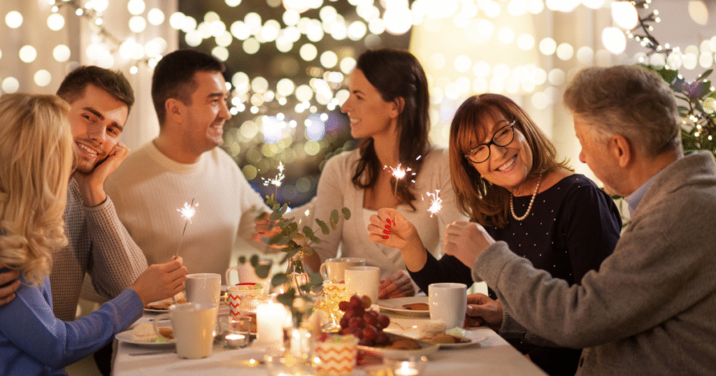 Group of people, smiling around a holiday table.