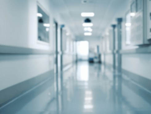 A blurred image of a clinical hallway, symbolizing treatment and recovery through medication-assisted treatment that includes medications for opioid use disorder (MOUD), counseling and support services.