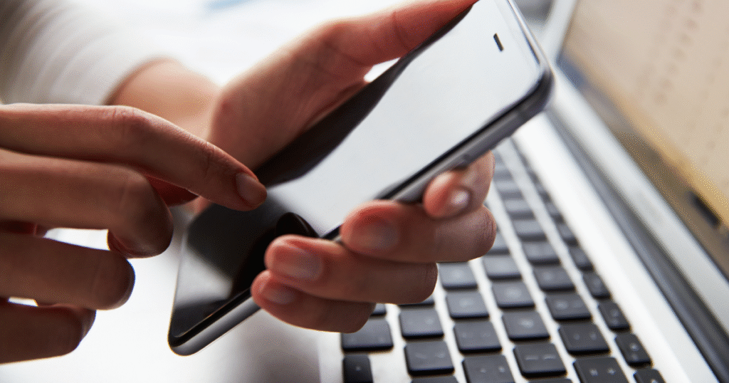 An individual on their phone doing telehealth, symbolizing the flexibility of technology in addiction treatment and recovery.