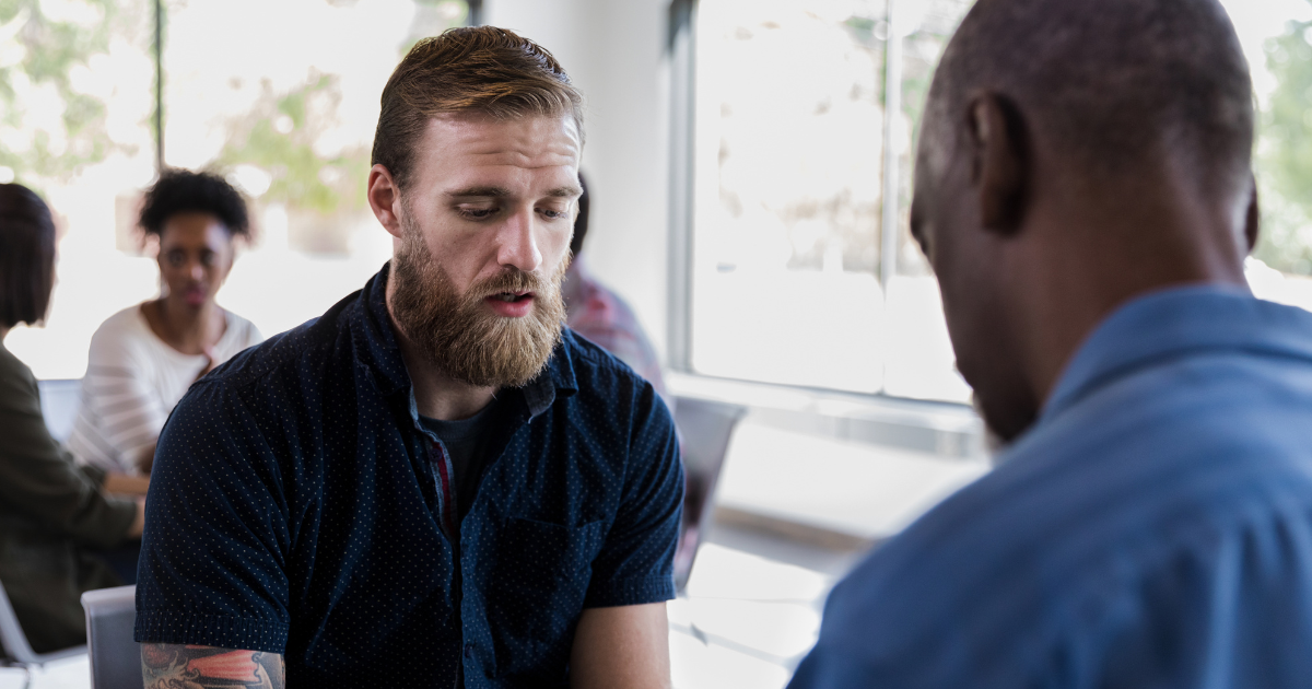 Man speaking with a counselor, representing someone on their journey to recovery from opioid use disorder through support and treatment.