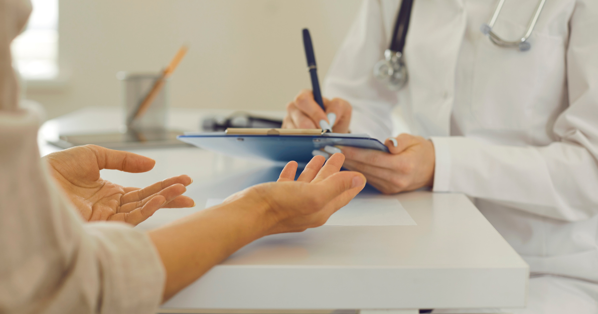 A healthcare professional and patient sit together in conversation, discussing Naltrexone as part of a recovery plan.