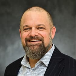 Professional headshot of Singletary, BHG Health addiction recovery specialist, smiling confidently.