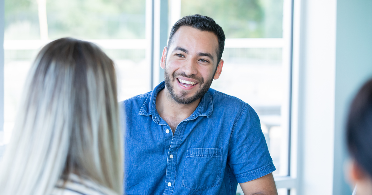 Man talking with a patient registration coordinator about his financial options.