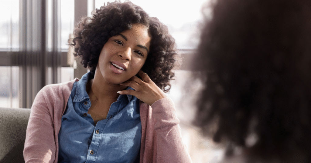 A woman talking with a financial counselor about insurance coverage for addiction treatment and recovery.