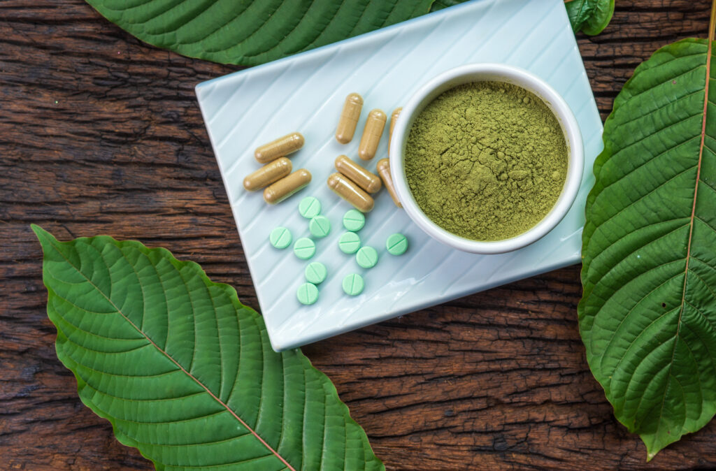Kratom powder, capsules and tablets representing kratom withdrawal symptoms and treatment options