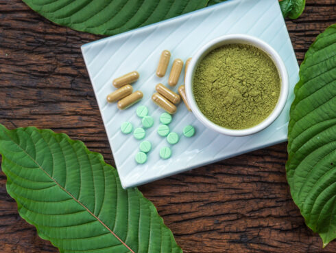Kratom powder, capsules and tablets representing kratom withdrawal symptoms and treatment options
