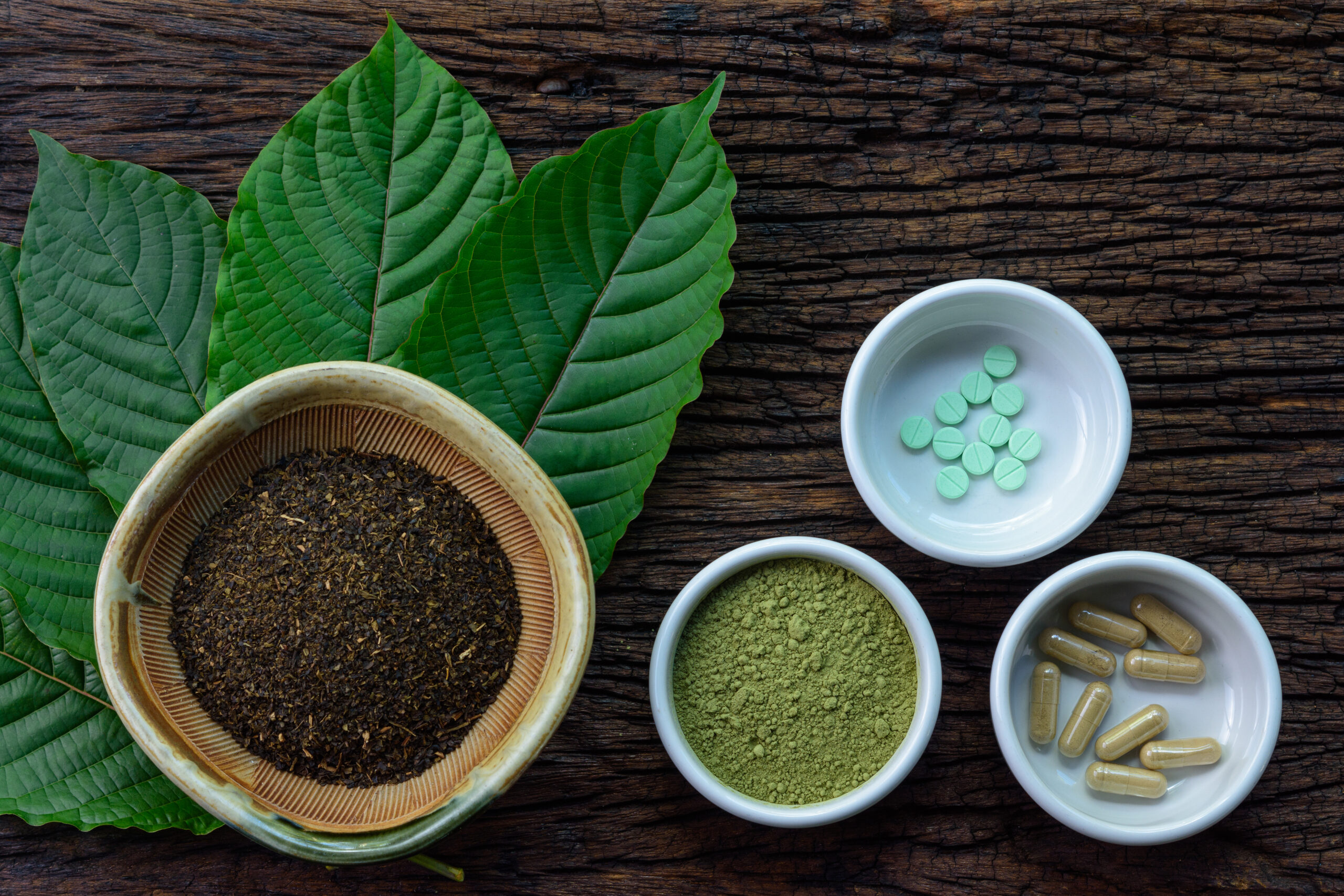 Various kratom products including dried leaves, powder and capsules, highlighting growing awareness of kratom ban regulations