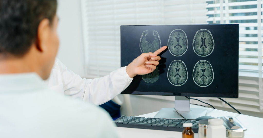 Healthcare professional reviewing brain scans that illustrate the brain’s ability to heal and adapt during recovery from substance use disorder.