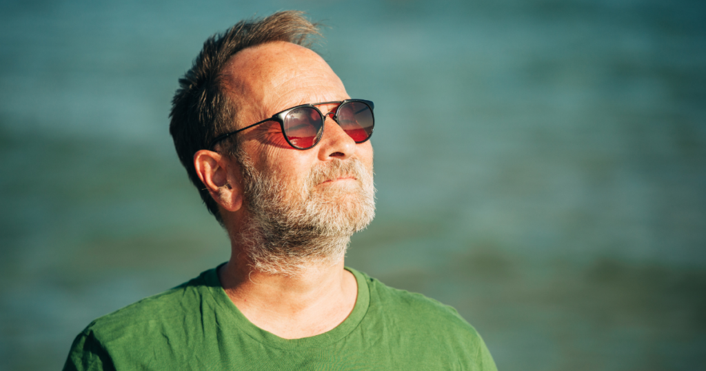 Person wearing sunglasses outdoors as part of a sun protection routine during recovery